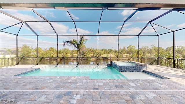 view of swimming pool with glass enclosure, an in ground hot tub, and a patio area