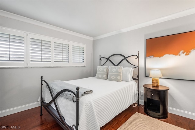 bedroom with dark hardwood / wood-style floors and ornamental molding