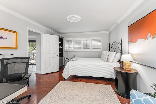 bedroom featuring crown molding and dark wood-type flooring