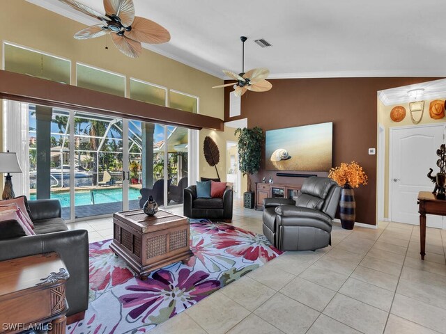 living room with ornamental molding, ceiling fan, and light tile floors
