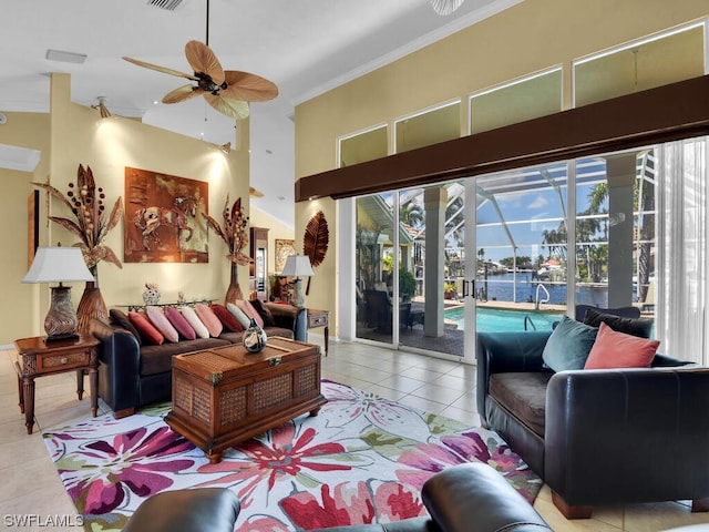 tiled living room with crown molding, a water view, ceiling fan, and a high ceiling
