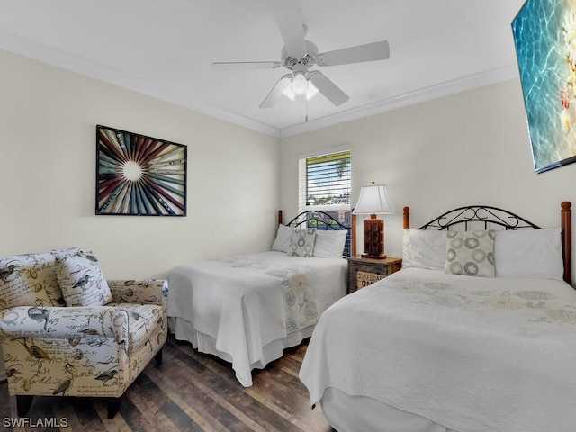 bedroom with crown molding, dark hardwood / wood-style flooring, and ceiling fan
