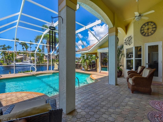 view of pool featuring a lanai, ceiling fan, and a patio