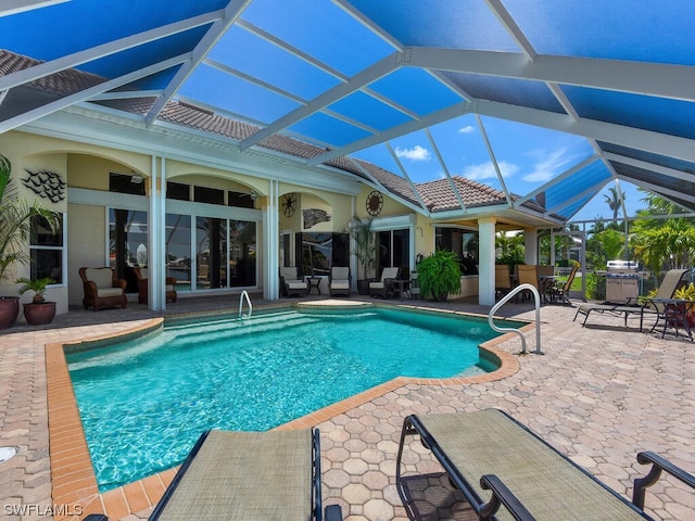 view of swimming pool with glass enclosure and a patio