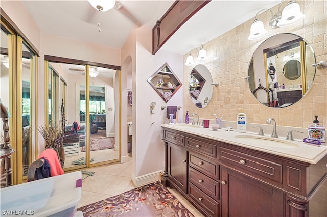 bathroom featuring ceiling fan, vanity, tasteful backsplash, and tile patterned flooring