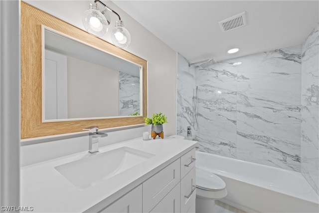 full bathroom with tiled shower / bath, toilet, and vanity