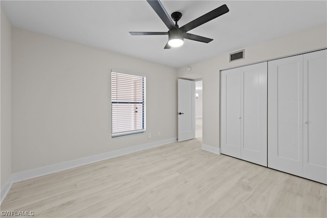 unfurnished bedroom featuring a closet, ceiling fan, and light wood-type flooring