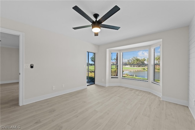 spare room with ceiling fan and light wood-type flooring