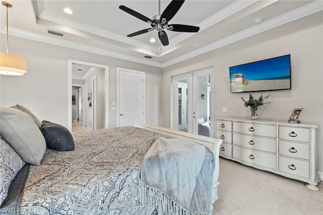 bedroom featuring ceiling fan, a tray ceiling, crown molding, light carpet, and french doors