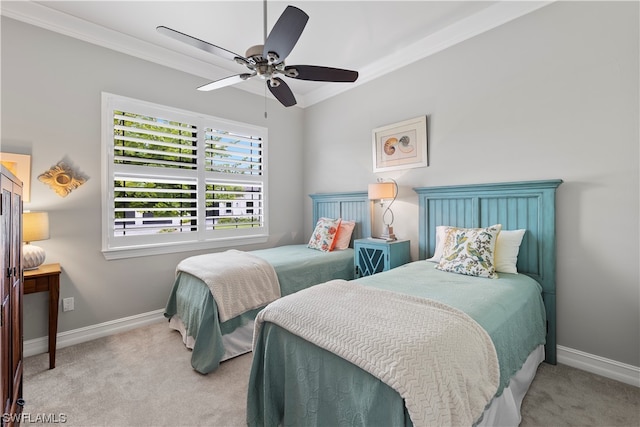 carpeted bedroom featuring ceiling fan and ornamental molding