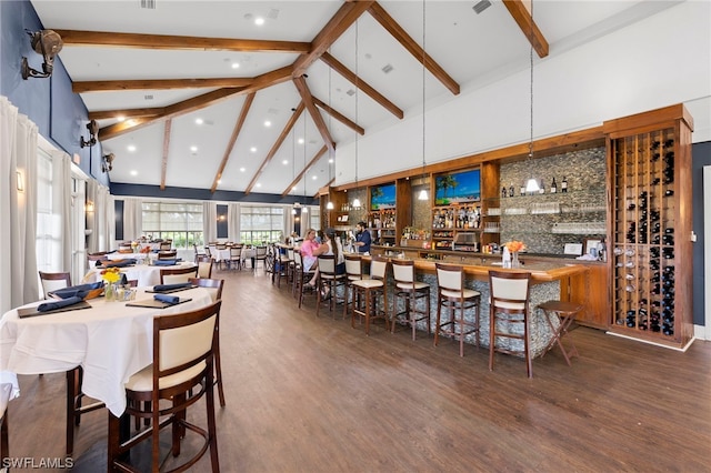 dining space featuring beamed ceiling, dark hardwood / wood-style floors, and high vaulted ceiling