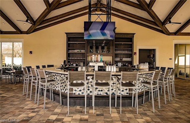 dining area with high vaulted ceiling, ceiling fan, and beamed ceiling