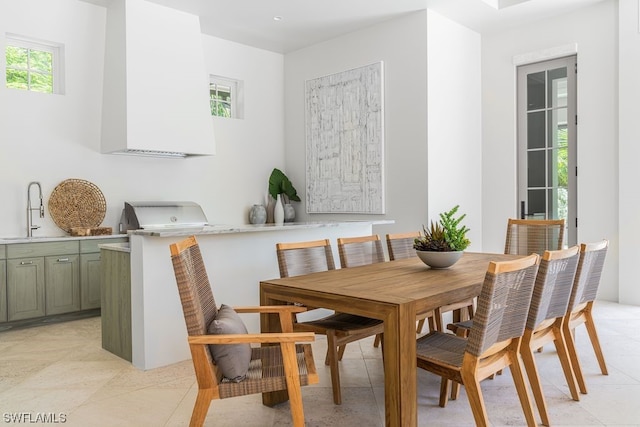 dining space with light tile floors and sink