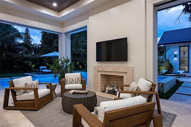 view of patio featuring an outdoor living space with a fireplace