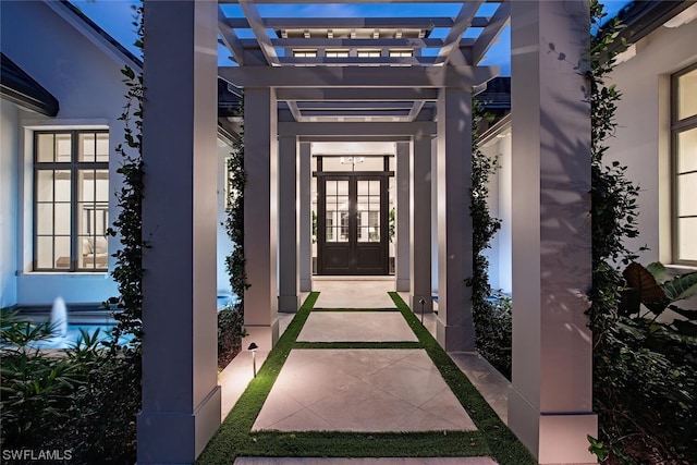 doorway to property with a pergola and french doors