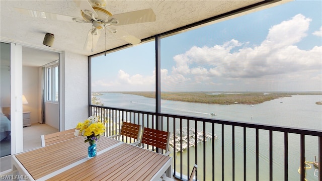4753 Estero Blvd Unit 1005, Fort Myers Beach, FL 33931 - balcony with a water view, a ceiling fan, and outdoor dining area