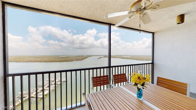 4753 Estero Blvd Unit 1005, Fort Myers Beach, FL 33931 - unfurnished sunroom with a water view, a ceiling fan, outdoor dining space, and healthy amount of natural light