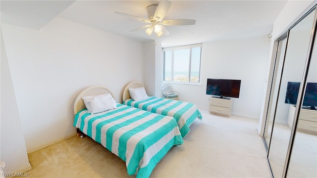 4753 Estero Blvd Unit 1005, Fort Myers Beach, FL 33931 - bedroom with light carpet, a closet, baseboards, and ceiling fan