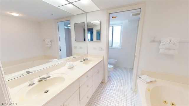 4753 Estero Blvd Unit 1005, Fort Myers Beach, FL 33931 - bathroom featuring toilet, double vanity, a jetted tub, and tile patterned floors