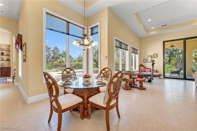 dining room featuring light tile patterned flooring, a chandelier, and plenty of natural light