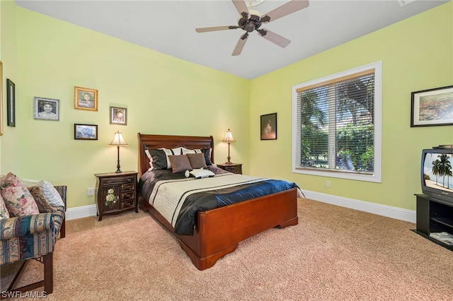 bedroom with light colored carpet, baseboards, and ceiling fan