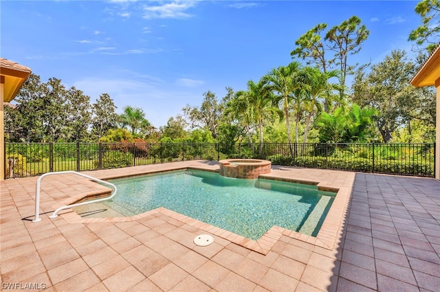 view of pool with a pool with connected hot tub, a patio, and fence