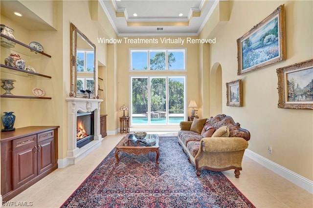 tiled living room featuring ornamental molding and a high ceiling