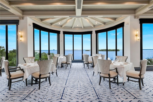 sunroom / solarium featuring a wealth of natural light, a water view, coffered ceiling, and beamed ceiling