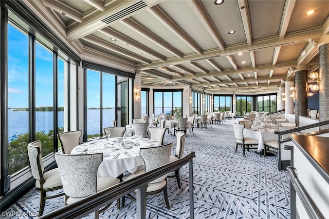 sunroom with beam ceiling, a water view, and coffered ceiling