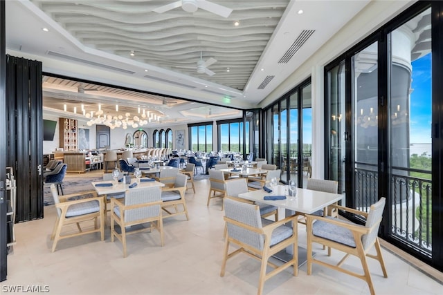 dining room featuring ceiling fan and expansive windows