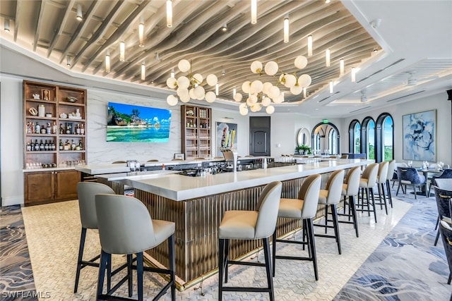 bar with a tray ceiling, indoor wet bar, and decorative backsplash