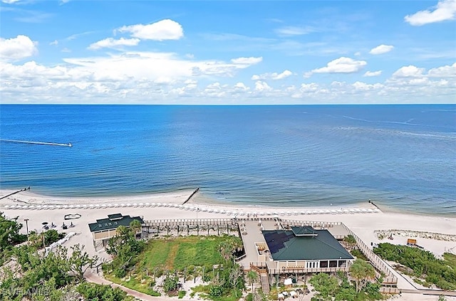 bird's eye view featuring a water view and a beach view