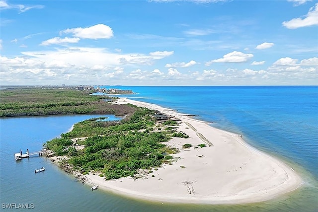 birds eye view of property with a water view and a beach view