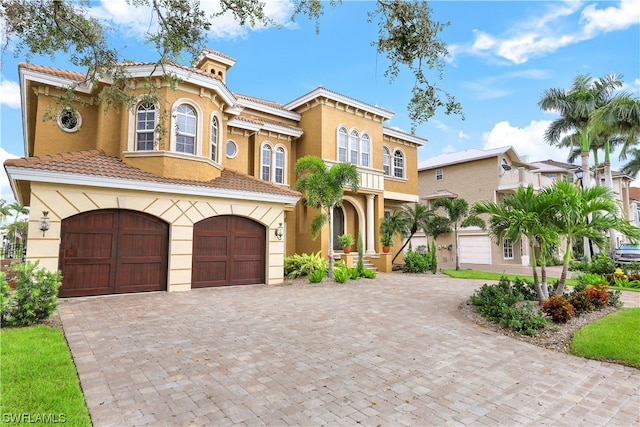 mediterranean / spanish-style house with a garage