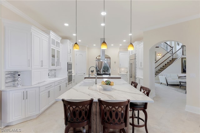 dining area with light tile floors, sink, and crown molding