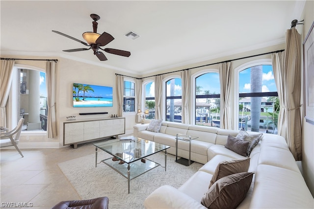 tiled living room featuring ornamental molding and ceiling fan