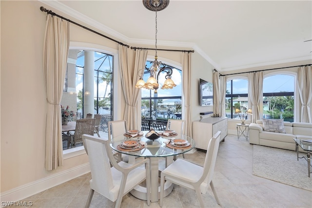 tiled dining space with a chandelier, plenty of natural light, and ornamental molding