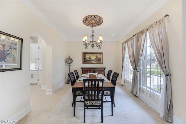 carpeted dining area with a chandelier and ornamental molding