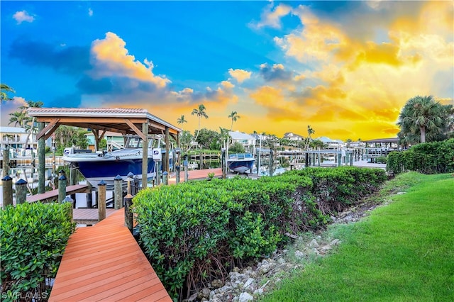 dock area featuring a water view and a yard