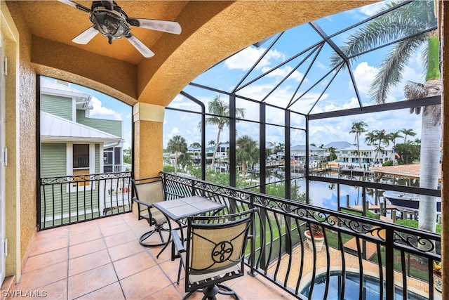 balcony with a water view and ceiling fan