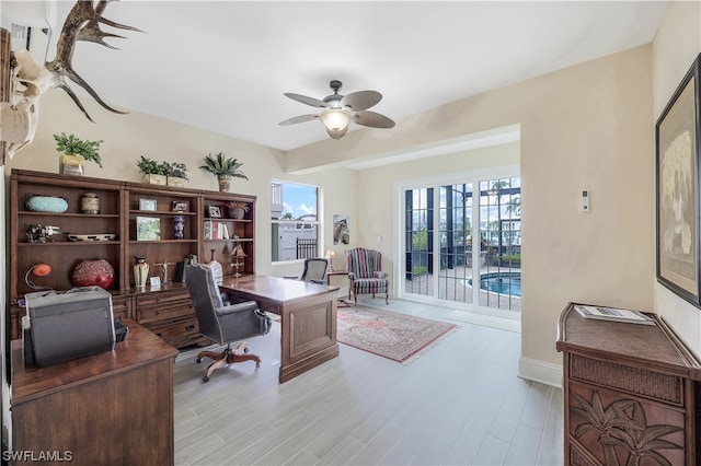 office area featuring light hardwood / wood-style floors and ceiling fan