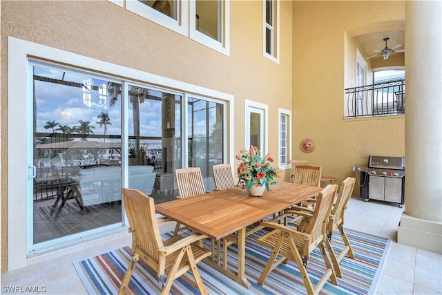 dining room with light tile flooring, a high ceiling, and ceiling fan