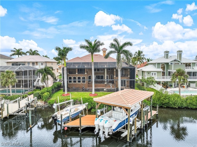 view of dock with a balcony, glass enclosure, and a water view