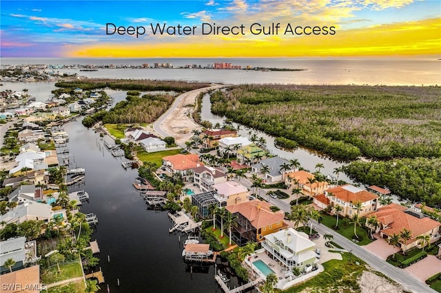 aerial view at dusk with a water view