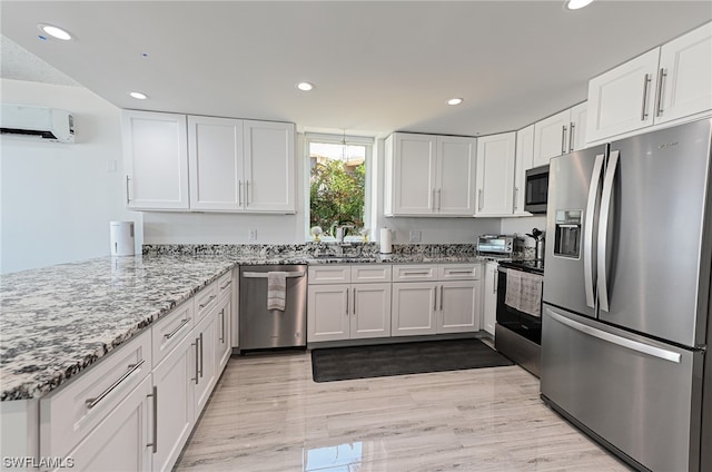 kitchen with white cabinets, light hardwood / wood-style flooring, appliances with stainless steel finishes, and sink