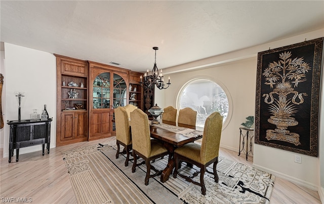 dining area featuring a chandelier and light hardwood / wood-style flooring