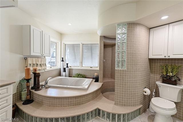 bathroom featuring toilet, a bath to relax in, backsplash, tile flooring, and vanity