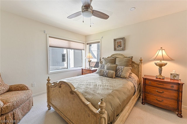 bedroom featuring light carpet and ceiling fan