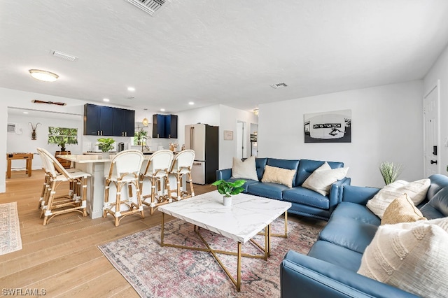 living room with light hardwood / wood-style flooring