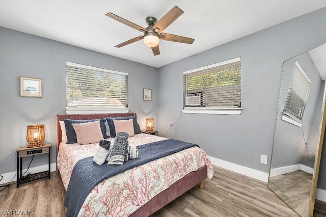 bedroom with dark hardwood / wood-style floors and ceiling fan